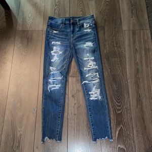 dark blue skinny jean with patched rips